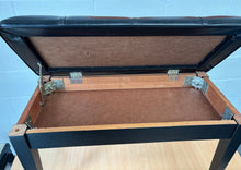 Load image into Gallery viewer, Black polished piano stool with seamed upholstered leatherette top and storage