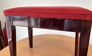 Polished black piano stool with red upholstered fabric top & storage