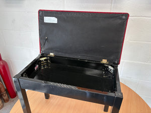 Polished black piano stool with red velour top & storage