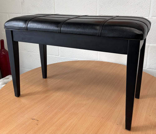Black polished piano stool with seamed upholstered leatherette top and storage